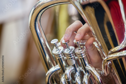 Close-up of a musician's hand playing the tuba