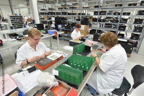 women at work in the production of microelectronics in a modern industrial factory