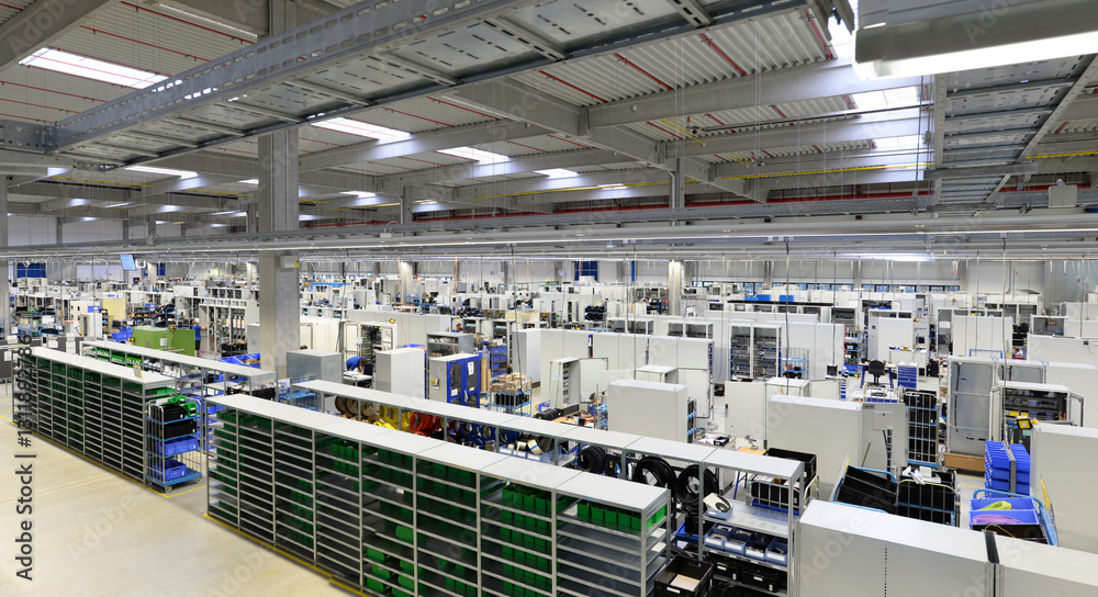 © industrieblick - modern industrial hall - production site of a factory for the assembly of electrical equipment in switchgear cabinets in mechanical engineering - machinery and equipment at the workplace