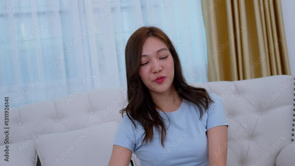 Happy young Asian woman showing dollar on camera and smiling excitedly in the living room at home. Winner Success business woman throws cash flow, smiling face, saves money, lottery money Happy young Asian woman showing dollar on camera and smiling excitedly in the living room at home. Winner Success business woman throws cash flow, smiling face, saves money, lottery money