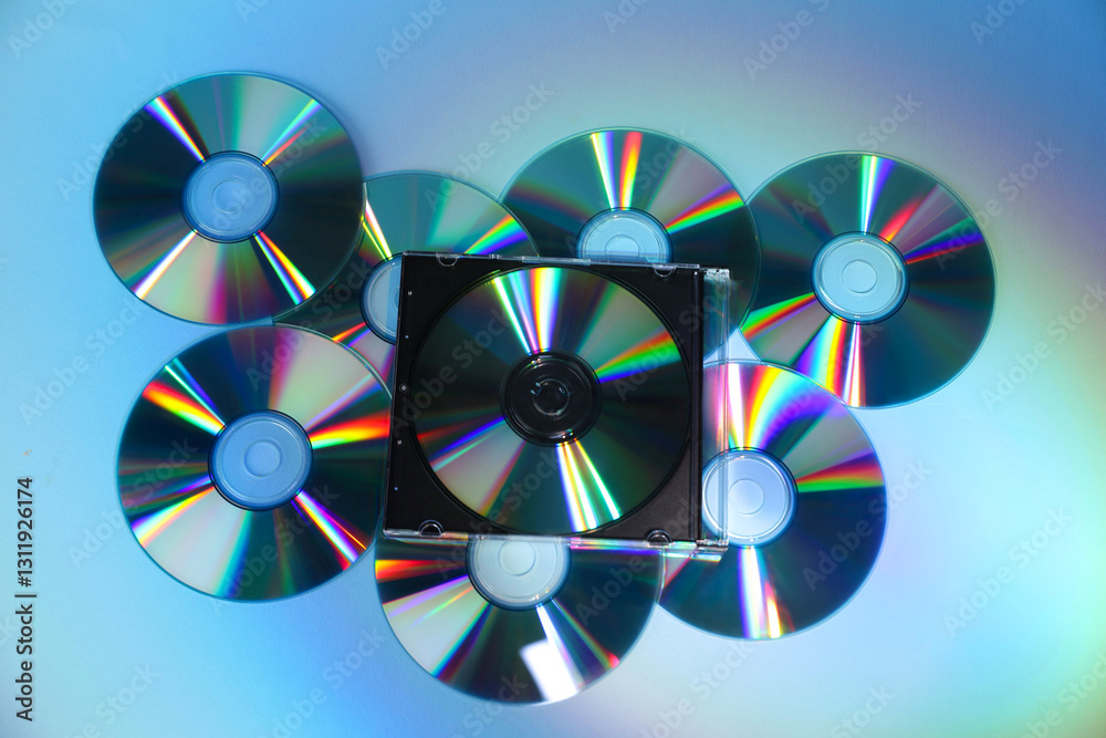 Many compact discs on light blue background, top view Many compact discs on light blue background, top view
