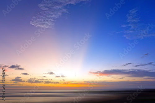 Fototapeta Naklejka Na Ścianę i Meble -  Sunrise over the sea. Light of the beautiful sunset over horizon in the beach with colorful sky. Sunset sunrise sky background. Sky clouds backgrounds. Romantic sunset. Morning light of the sunrise.