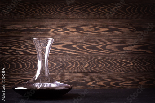 Decanter with red wine on wooden rustic background