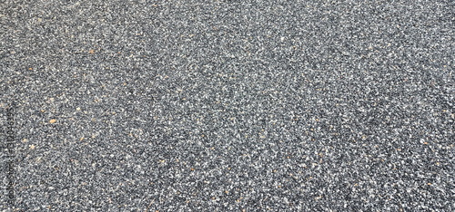 Asphalt road background. showcasing its detailed texture and fine gravel composition. Seamless tarmac dark grey grainy road, Asphalt, Street, concrete highway surface. Pattern with grainy structure,
