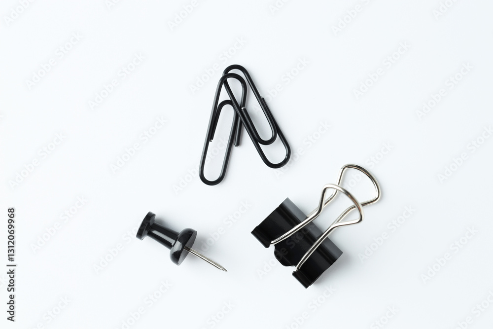 Paper clips and pin on white background, flat lay Paper clips and pin on white background, flat lay