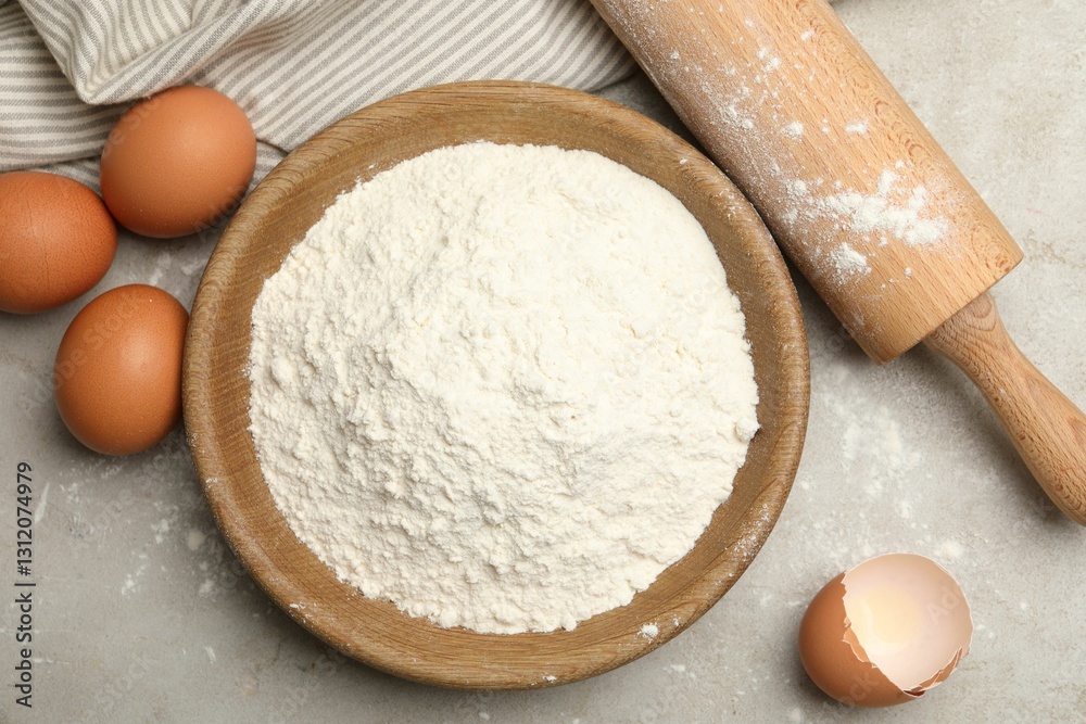 Rolling pin, flour and eggs on light grey background, flat lay Rolling pin, flour and eggs on light grey background, flat lay