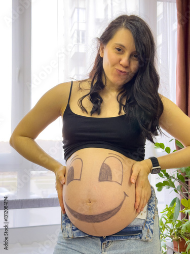 Pregnant Woman with Smiley Face Belly Art