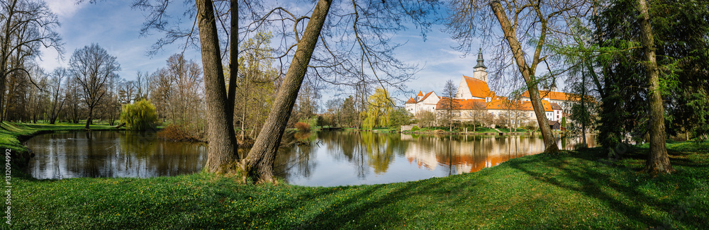 Fototapeta premium Telc and park with pond in spring, old town in Czech Republic