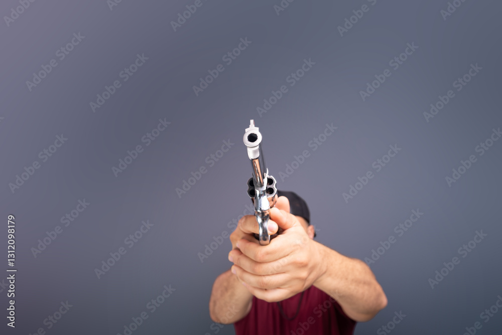 Studio portrait of a shooting instructor pointing a revolver to the side. isolated on gray background. Sport practice. Studio portrait of a shooting instructor pointing a revolver to the side. isolated on gray background. Sport practice.