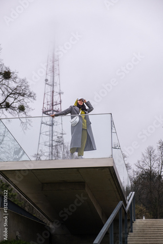 Obraz na płótnie stylish woman on outdoors balcony at fogy weather w salonie