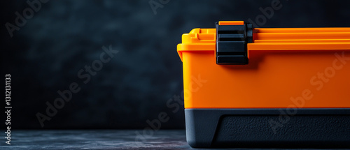 Orange plastic toolbox on dark background photo