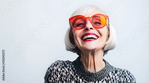 Radiant and Confident Senior Woman with Gray Hair Smiling Joyfully in Vibrant Multicolored Patterned Sweater Exuding a Positive and Energetic Vibe as an Active and Independent Older Adult