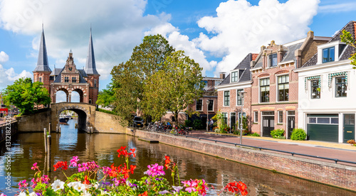 The famous Waterpoort gate in Sneek on a sunny day with flowers in bloom, Friesland, Netherlands photo