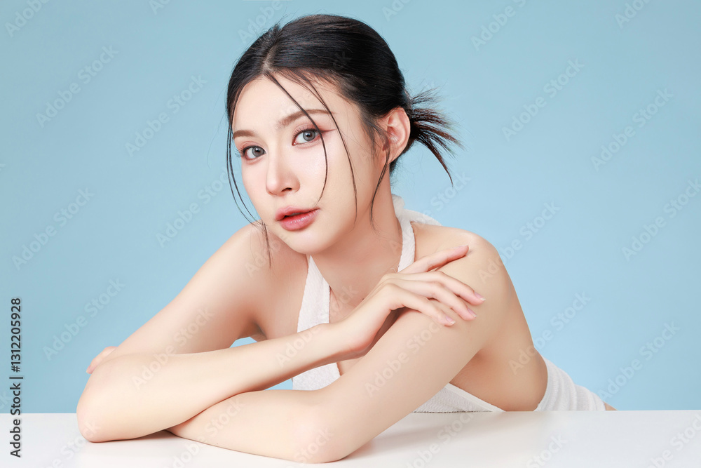 Beautiful young Asian woman model bun hair with natural makeup on face clean fresh skin on isolated blue background. Cute girl portrait, Facial treatment, Body care, Beauty and Spa. Beautiful young Asian woman model bun hair with natural makeup on face clean fresh skin on isolated blue background. Cute girl portrait, Facial treatment, Body care, Beauty and Spa.
