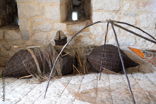 A fishing net is a net used for fishing. Nets are devices made from fibers woven in a grid-like structure. Some fishing nets are also called fish traps, wooden basket.