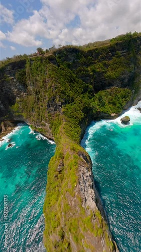 Cinematic FPV flight over scenic cliffs and turquoise ocean waters on Nusa Penida Island, Bali, Indonesia