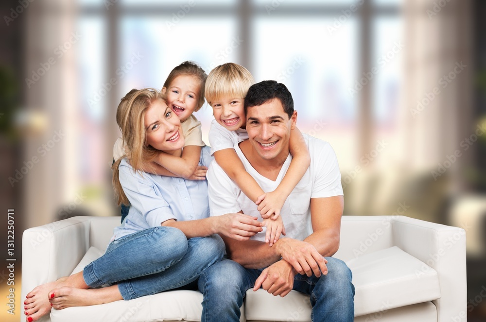 Parents and children relaxing on comfortable couch in living room