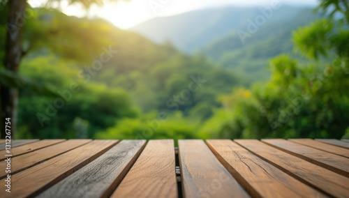 Empty wooden table with a beautiful blurred green mountain view in the background. Perfect for product placement, showcasing nature, or creating a serene atmosphere.