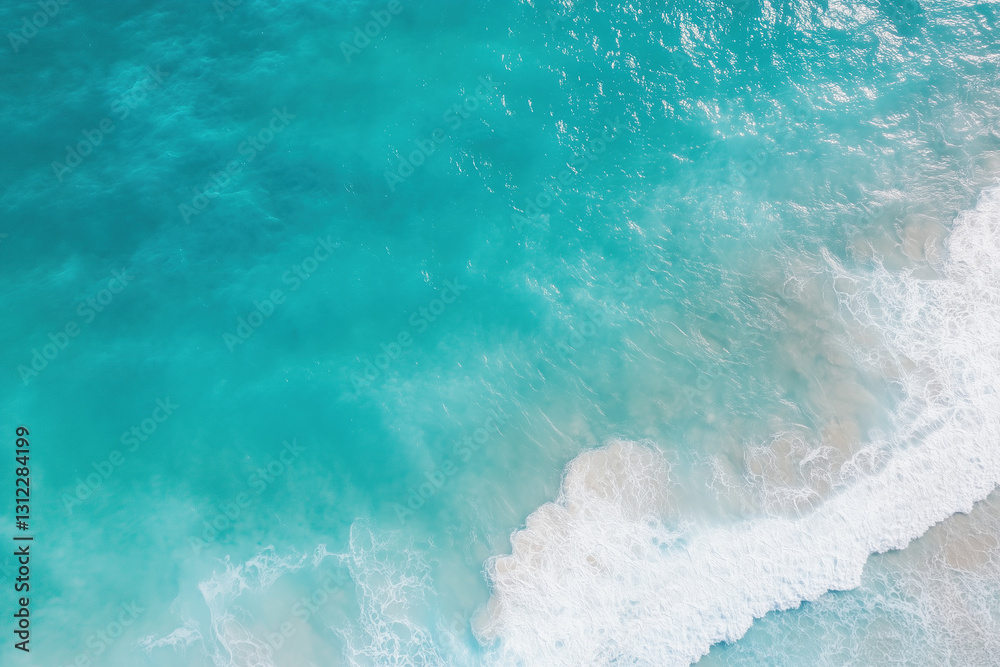 Obraz premium Aerial view of crystal-clear turquoise ocean waves rolling onto a soft sandy beach. 