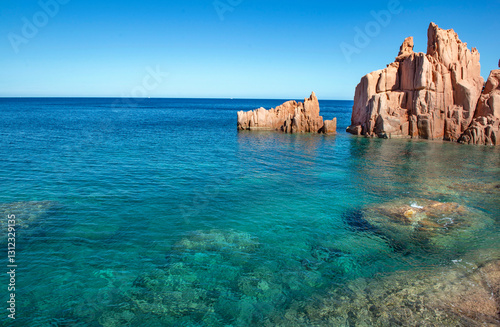 Fototapeta Naklejka Na Ścianę i Meble -  formation of red granite rocky peak on  clear sea in Sardinia Italy - Rocce Rosse Arbatax.