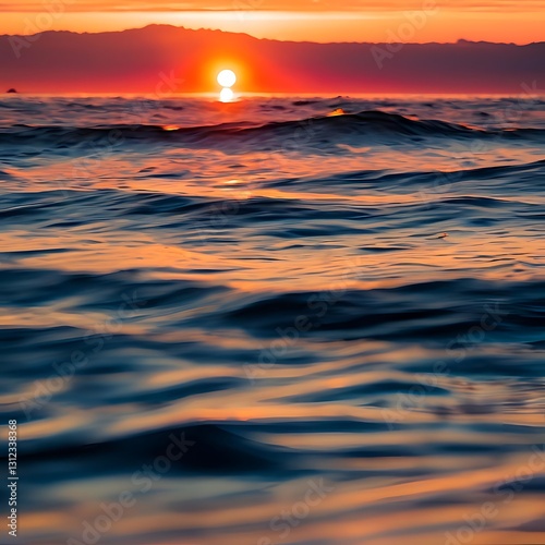 Serene Ocean Sunset with Vibrant Orange Glow, Gentle Waves, and Majestic Cloud Cover – A Captivating Natural Landscape for Stock Photography