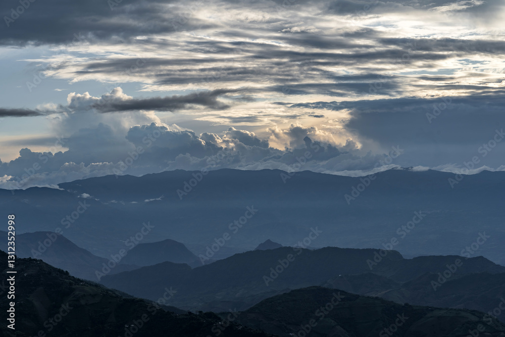 Fototapeta premium Rain clouds in dark tones in the Andean mountain range of Colombia, a dramatic landscape scene. Silhouette of mountains in the midst of a storm.