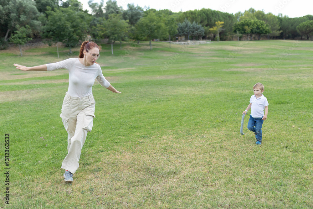 Mother and son playing airplane in the park Mother and son playing airplane in the park