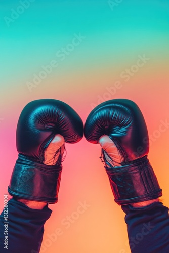 close-up of pair of gloved hands poised for fight against blurred out action-packed background with gradient colors