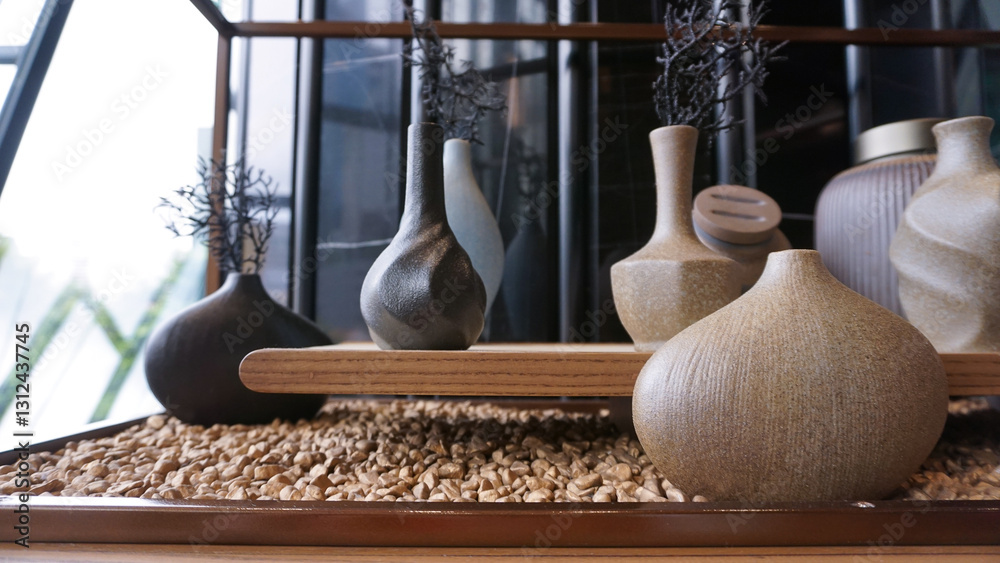 Beige ceramic vases with dry cotton branches. Neutral trendy colors interior decoration .
