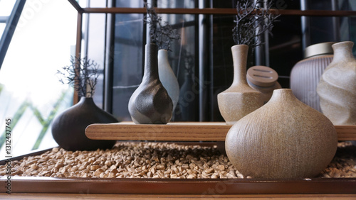 Obraz na płótnie Beige ceramic vases with dry cotton branches. Neutral trendy colors interior decoration . w salonie