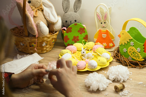 child makes paper flowers for easter gift to teacher or mom photo