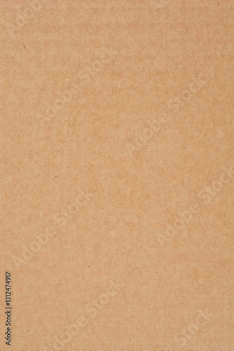 A flat surface of uniform brown cardboard fills the entire frame, showcasing its texture and color