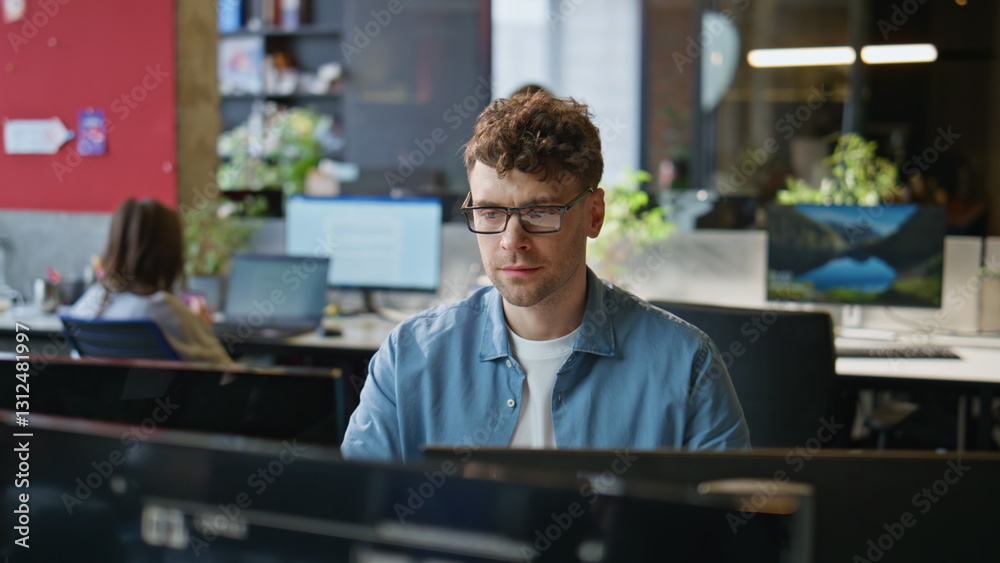 Eyeglasses guy corresponding client using computer at corporate office closeup Eyeglasses guy corresponding client using computer at corporate office closeup