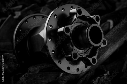 Black bicycle hub placed on dark coal background. Professional bike bearings.