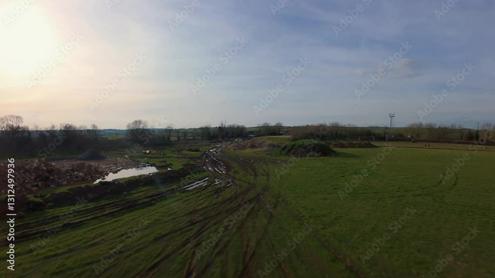 FPV aerial drone over fields on a sunny day fast sport mode close proximity spring time FPV aerial drone over fields on a sunny day fast sport mode close proximity spring time