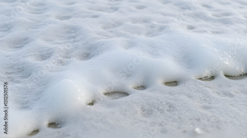 Close-up View of Seafoam Bubbling at the Shoreline's Edge
