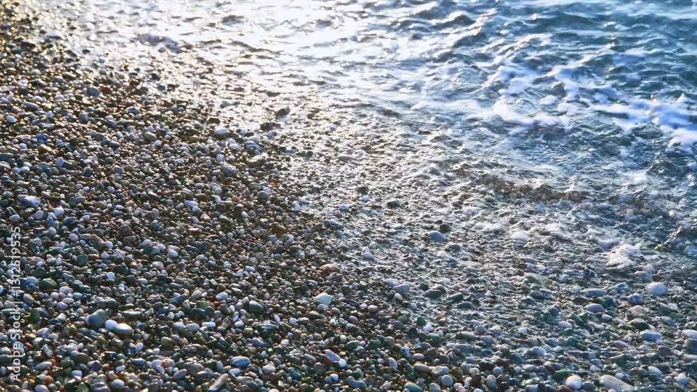 sea surf on a pebble beach, summer natural background, rest and relaxation by the sea sea surf on a pebble beach, summer natural background, rest and relaxation by the sea