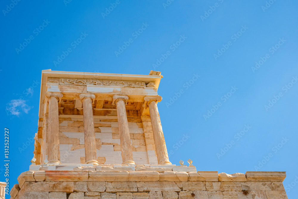 Obraz premium Architectural masterpiece, the Parthenon, a unique UNESCO world heritage archaeological site of Acropolis hill with beautiful scattered clouds and deep blue sky, Athens historic center, Attica, Greece