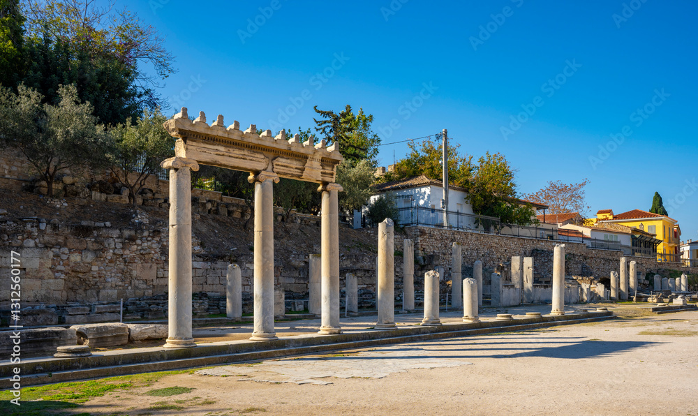 Fototapeta premium The most famous architectural landmarks of ancient greek heritage located in the Plaka district in Athens, Greece: the library of Hadrian, Wind tower, medieval mosque
