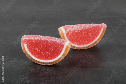 Vegan dessert. Jelly Marmalade "Grapefruit slices". Close-up. Dark background