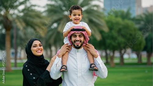 Wallpaper Mural Happy Arab family on vacation, father with child on shoulders and the mother smiling, in a park setting, enjoying holiday outdoors. Torontodigital.ca