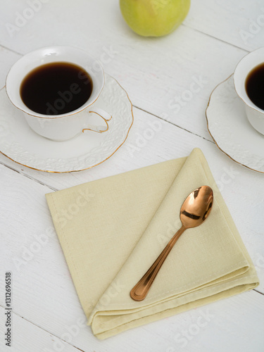 Yellow napkin on a white wooden table. Beautiful setting.