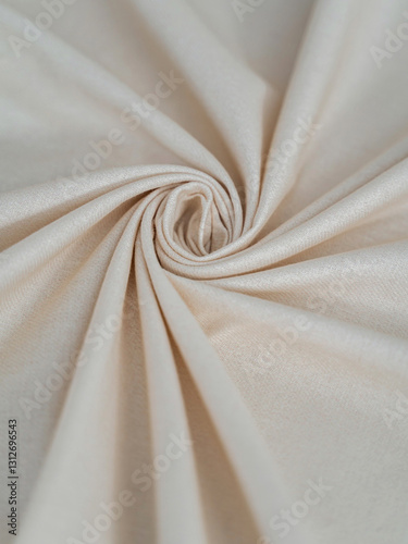 Soft beige fabric. Beautiful folds. Closeup.