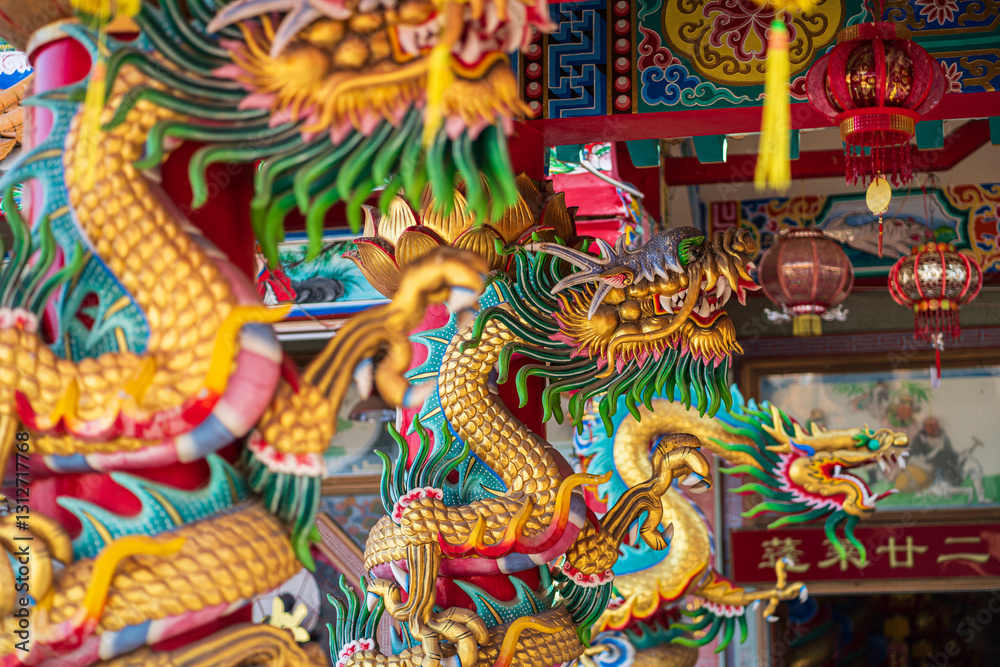 Beautiful Elegant double golden dragon statue on the roof of on a temple for Chinese New Year Festival at Chinese shrine with blue sky.