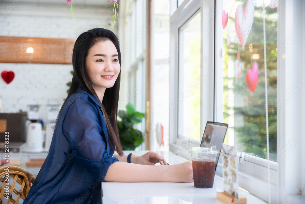 Asian freelance people business female talking making using casual working with laptop computer and coffee at home in the living room indoors artificial rose bouquet of red and pink roses rose vase