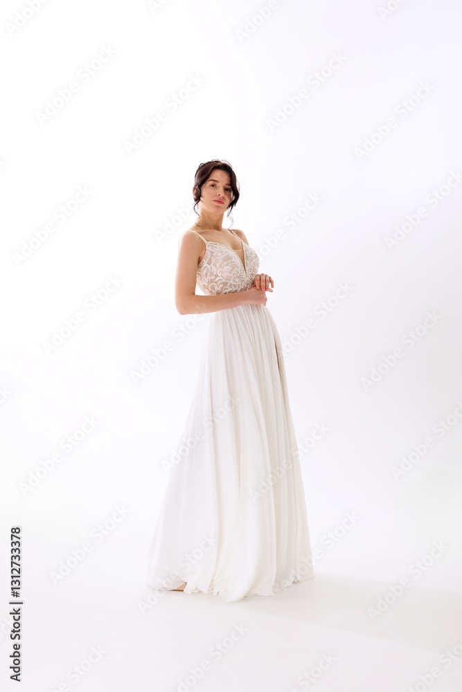Elegant bride in a flowing white dress showcasing grace and beauty during a wedding photography session in a minimalistic setting Elegant bride in a flowing white dress showcasing grace and beauty during a wedding photography session in a minimalistic setting