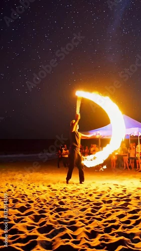 Dynamic fire dance under starry night sky on beachfront with enthralled audience