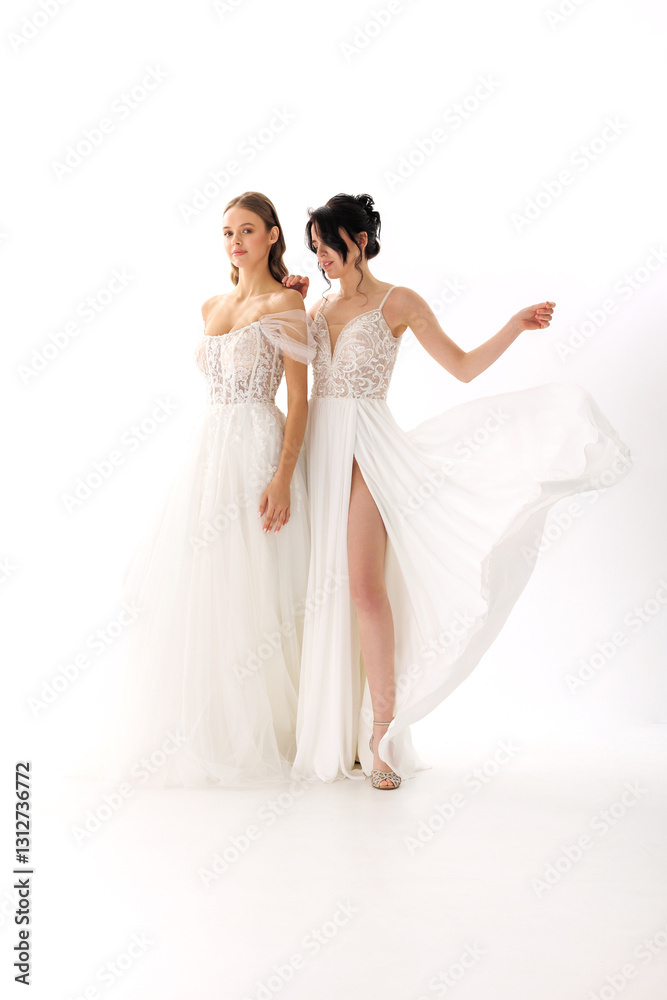 Elegant models showcase stunning white dresses in a fashion photoshoot set against a bright backdrop Elegant models showcase stunning white dresses in a fashion photoshoot set against a bright backdrop