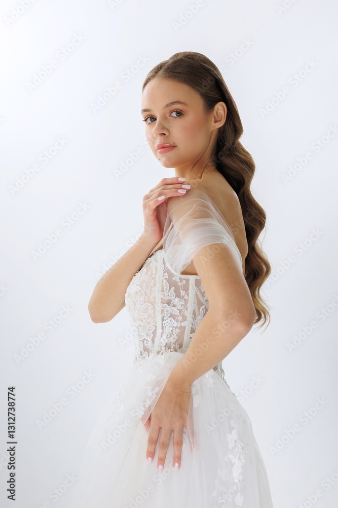 Elegant bride showcasing a bridal gown in a minimalistic studio setting during the daytime Elegant bride showcasing a bridal gown in a minimalistic studio setting during the daytime