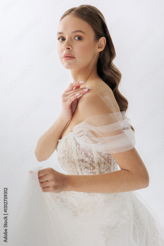 Elegant bride poses gracefully in a stunning white wedding dress against a soft backdrop Elegant bride poses gracefully in a stunning white wedding dress against a soft backdrop